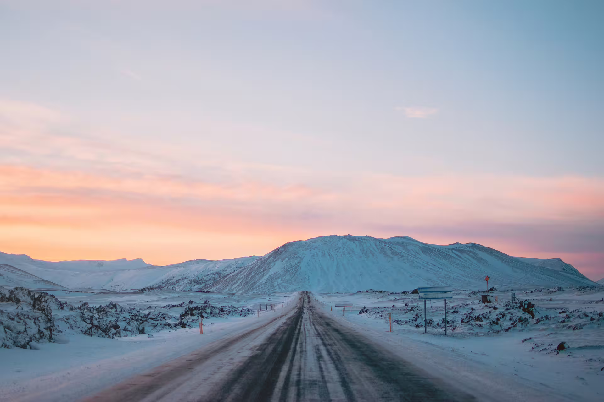 Scenic winter road through snow-covered Snaefellsnes Peninsula at sunset on a private Iceland day tour from Reykjavik
