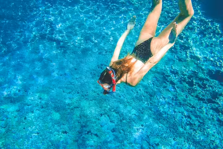 Snorkeling in the Blue Lagoon during the 3 Islands speedboat tour, exploring clear water and seabed
