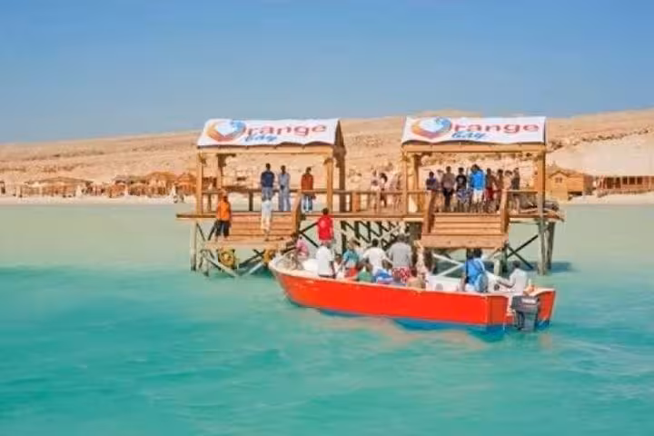 Boat arriving at Orange Bay Hurghada pier with guests, Red Sea snorkeling day tour from Luxor with transfers