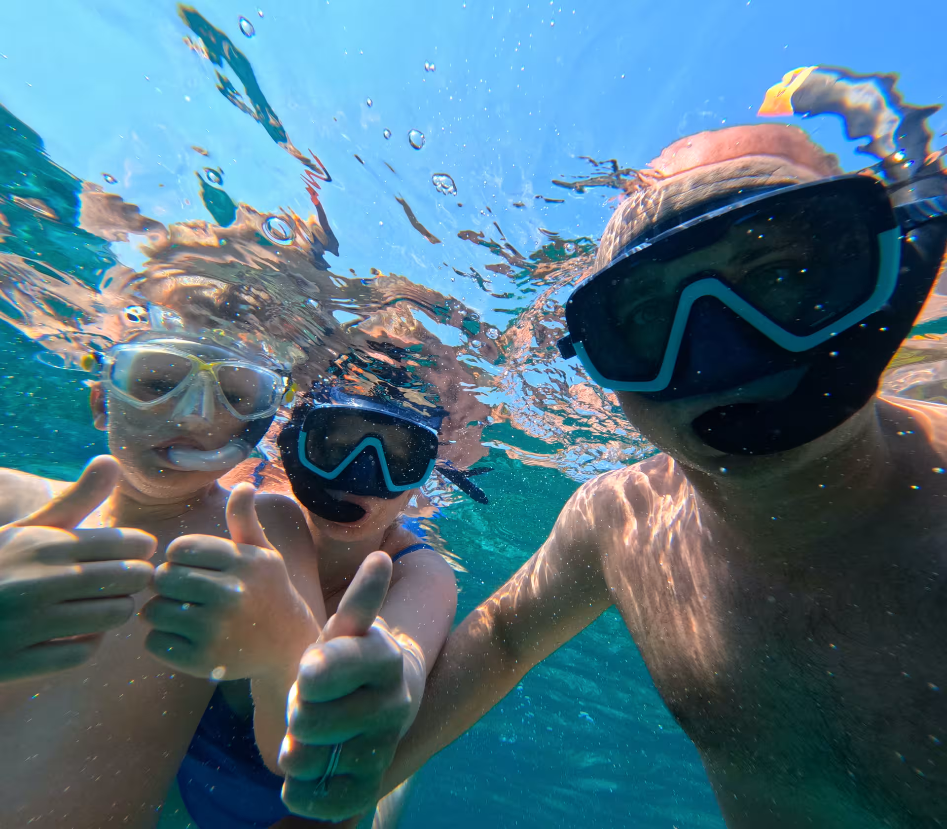 Snorkelers underwater in clear Adriatic sea, enjoying a Brač Island secluded bay stop on speedboat tour