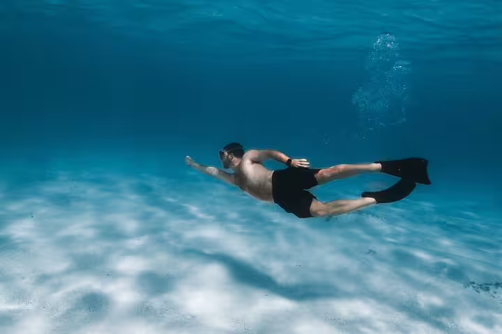 Snorkeler gliding over clear Red Sea waters near Mahmya Island, Hurghada, Egypt, on a snorkeling excursion