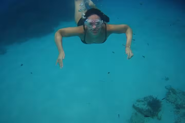 Snorkeling in crystal-clear waters at Paleokastritsa Corfu on a private tour to Corfu’s best beaches