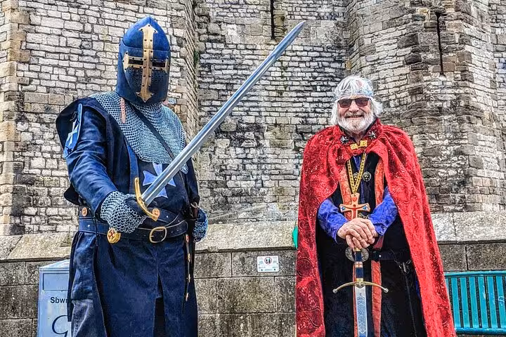 Medieval knight and costumed guide at Welsh castle on the Snowdonia & 3 Castles Tour day trip