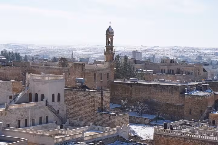 Snowy Mardin stone houses and historic bell tower view on an all-inclusive private guided Mardin city tour