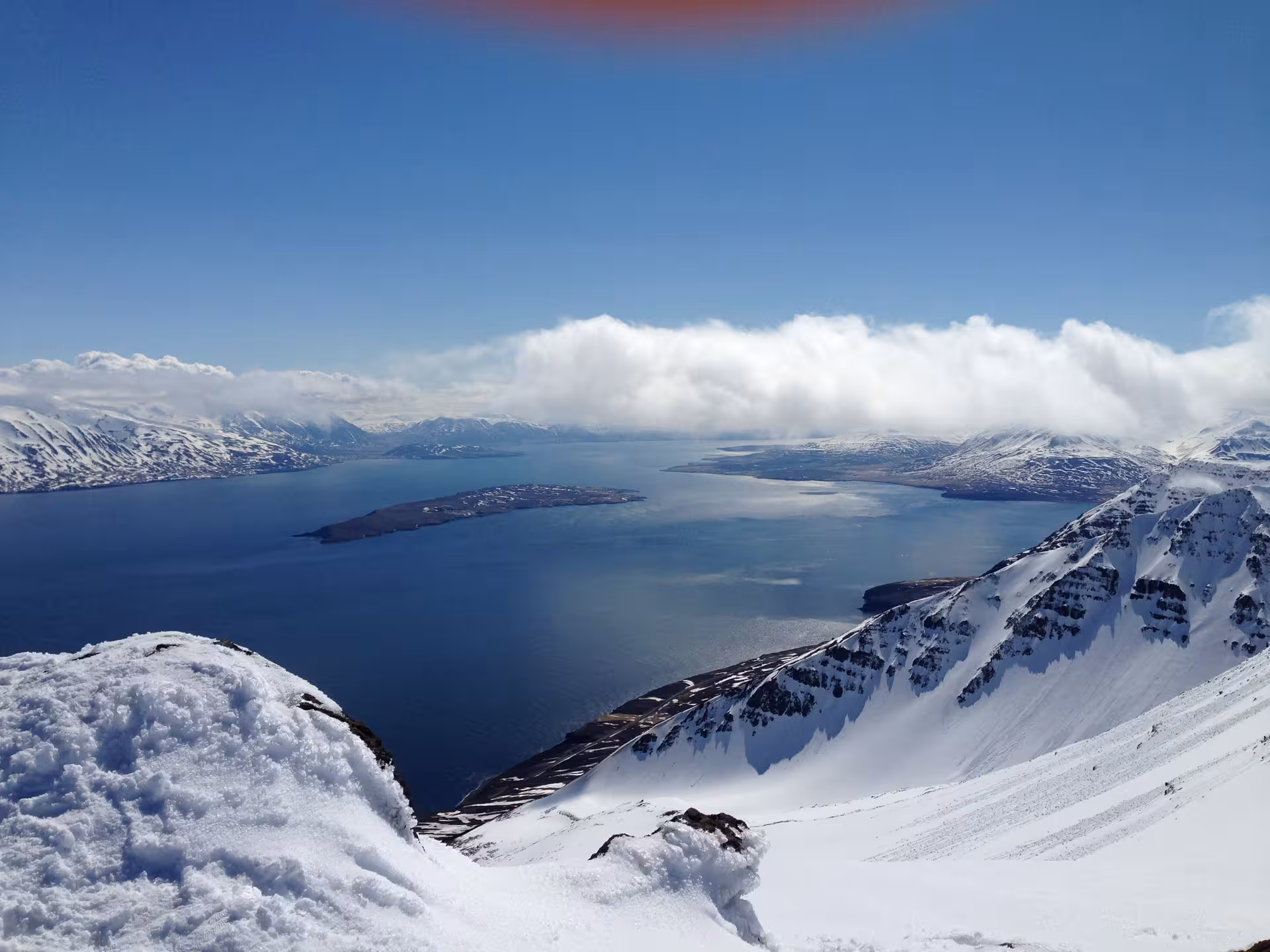 Scenic snowy mountain peaks overlooking a vast fjord, perfect for a custom photography day tour experience.