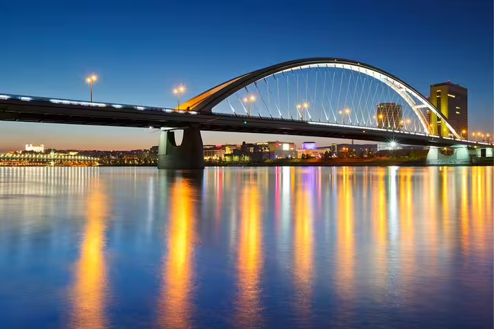 SNP Bridge in Bratislava glowing at night over the Danube, highlight on a self-guided scavenger hunt tour