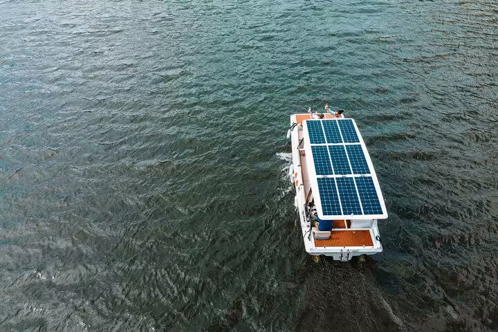 Solar-powered boat cruising on the Douro River, offering eco-friendly private tours and scenic views.