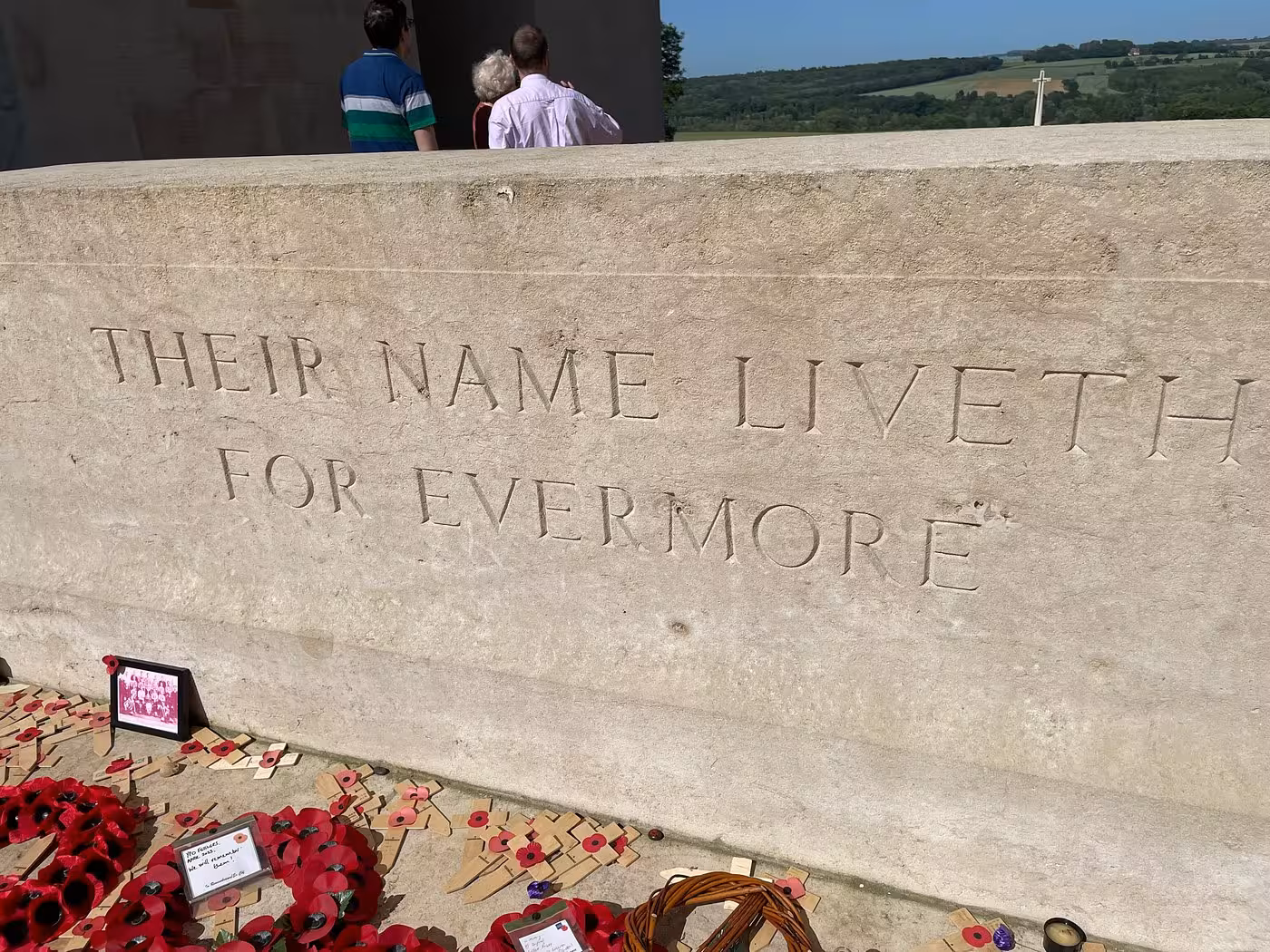 Stone memorial inscribed 'Their Name Liveth For Evermore' with red poppies at Somme Battlefields