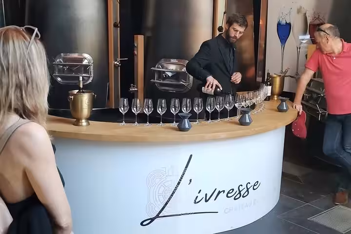 Sommelier pouring Provence wine at Château La Coste tasting bar during Wine Elegance discovery tour