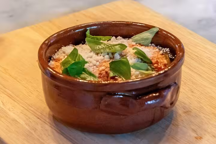 Traditional Italian dish with basil and cheese served in a rustic pot on the Sorrento Bites & Sips Tour.