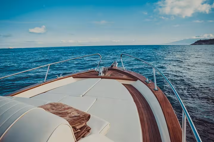 Experience a serene Sorrento to Capri tour on a classic Gozzo, with stunning views of the Mediterranean Sea.