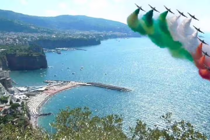 Panoramic view of Sorrento coastline and bay with Italian air show display on a private full day Amalfi Coast tour