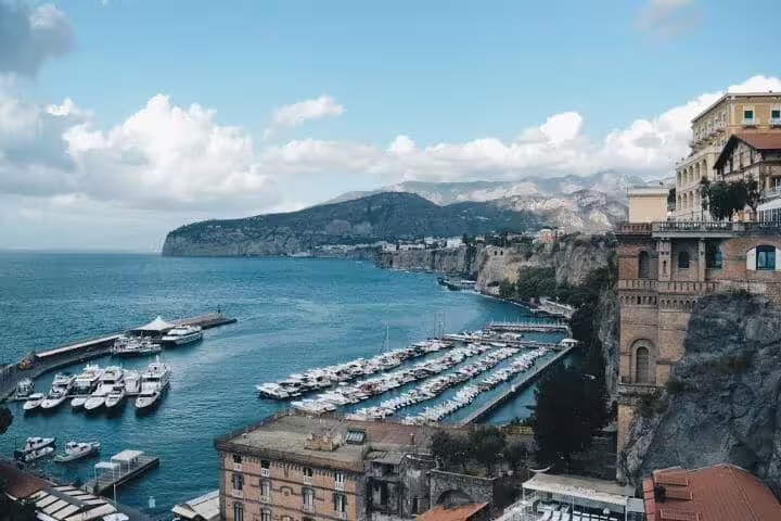 Panoramic view of Sorrento marina and cliffs on a sunny day, a highlight stop on a private full day Amalfi Coast tour