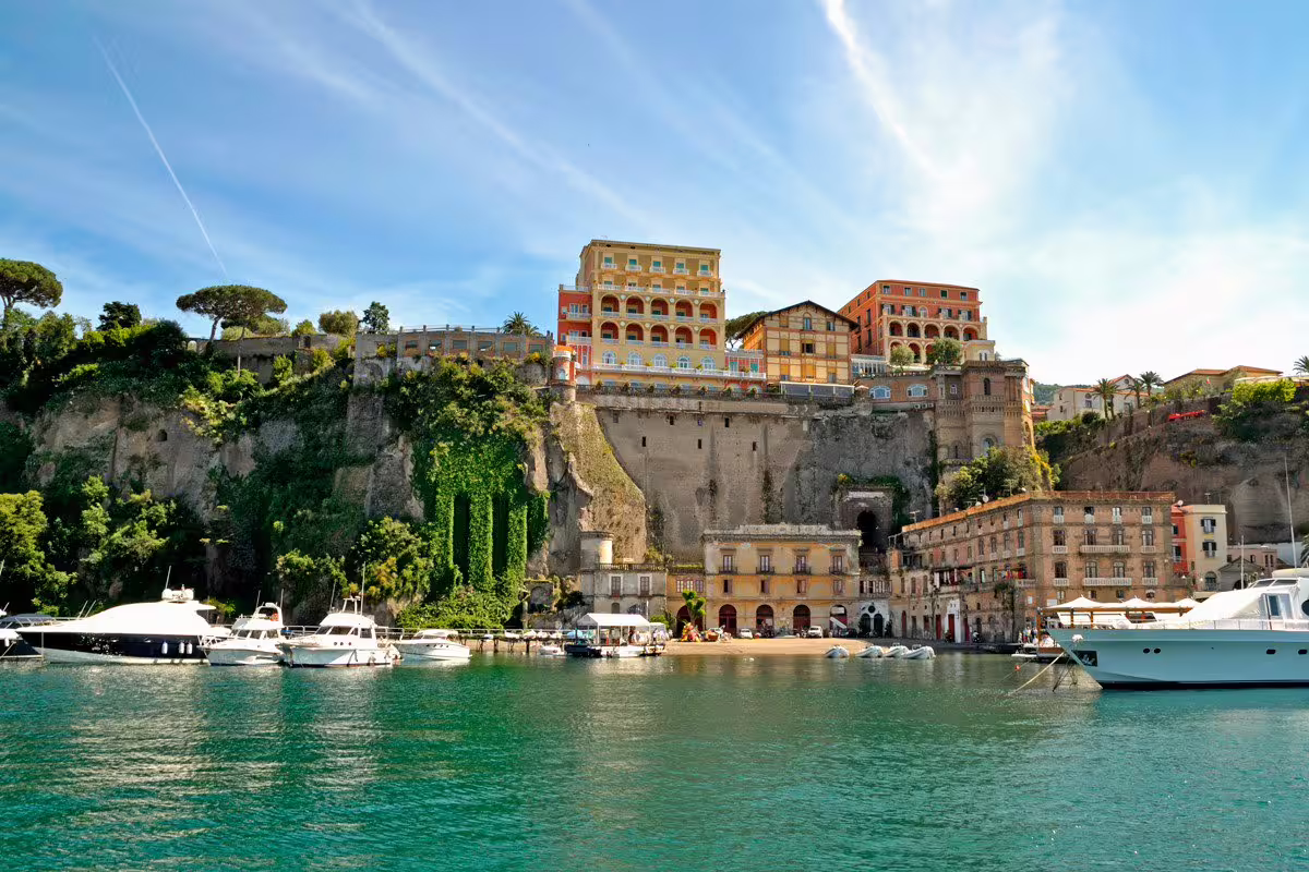 Sorrento Marina Grande harbor with yachts and cliff hotels on Sorrento Positano Amalfi Coast tour from Naples