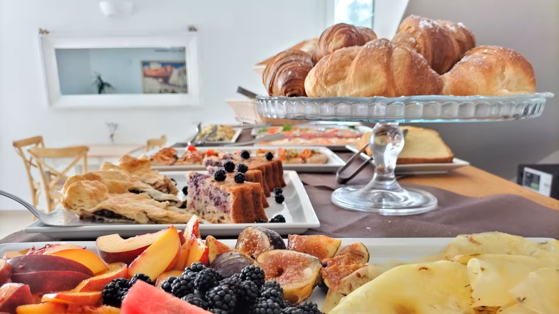 Delicious breakfast spread with pastries and fresh fruits at Sorso villa, enhancing your relaxing stay.