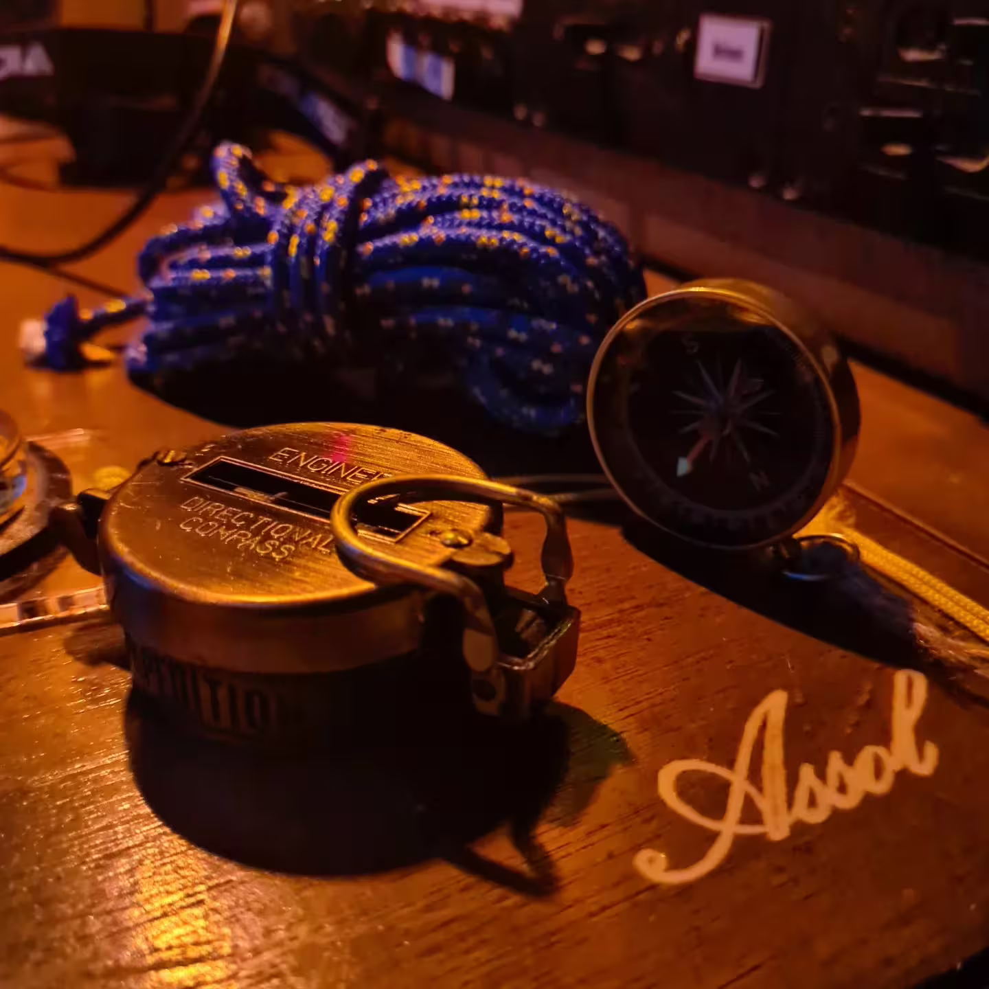 Vintage compass and nautical ropes on a wooden deck, symbolizing adventure on Sotogrande's private boat charters.