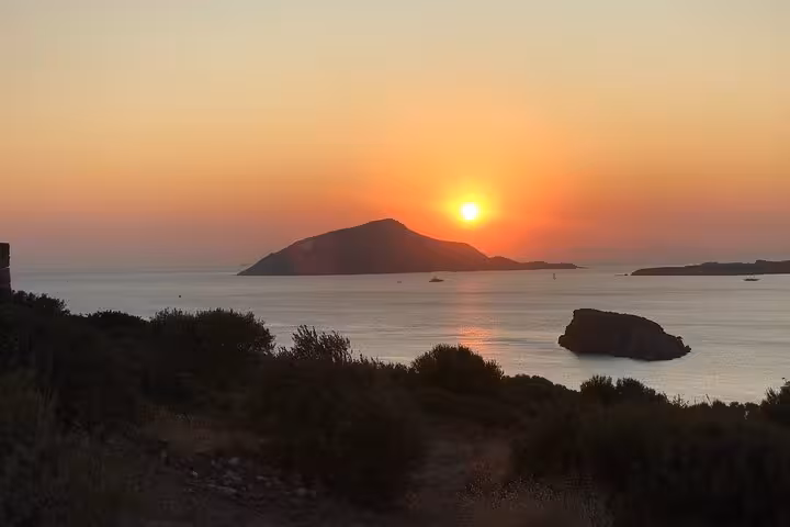 Scenic sunset view over the Aegean Sea with silhouetted island during Sounio Half Day Private Tour.