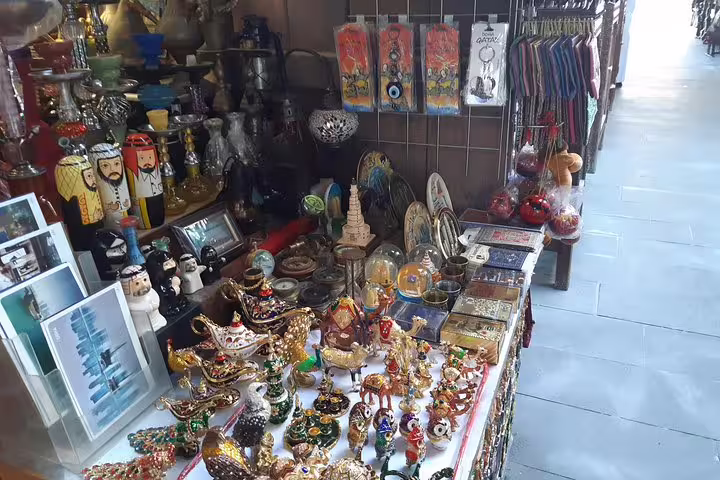 Colorful array of souvenirs and traditional crafts at a market stall in Souq Waqif, Doha, highlighting local culture.