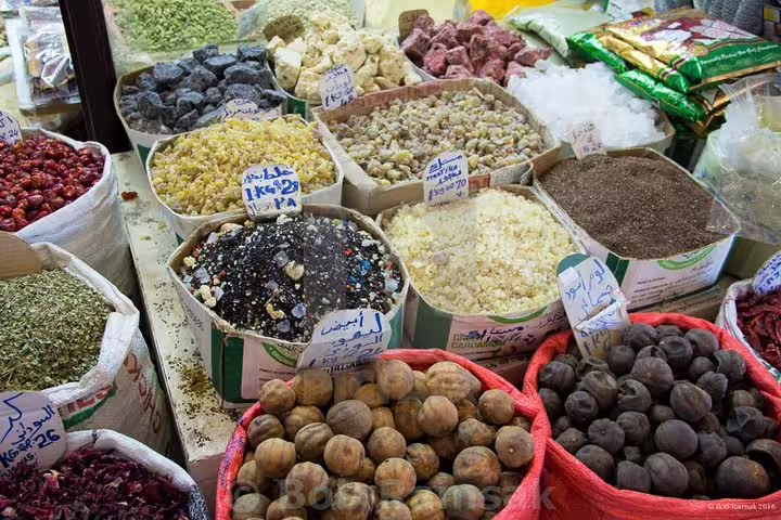 Vibrant display of spices and dried goods at Souq Waqif in Doha, showcasing local market culture and flavors.