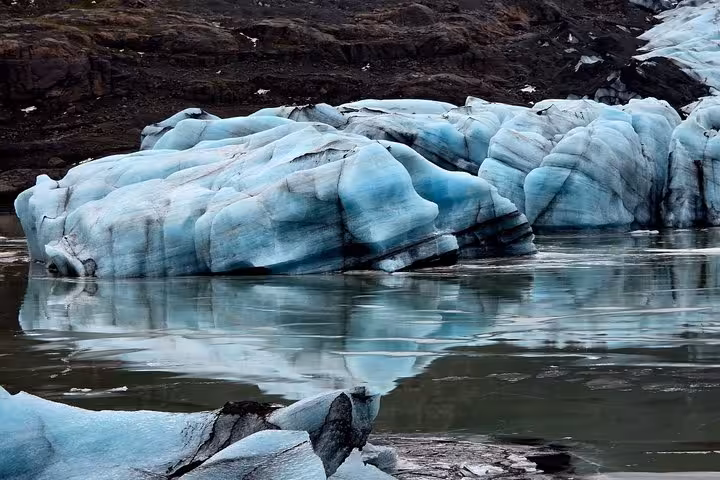 Blue glacial icebergs floating in a calm lagoon near Iceland's south coast