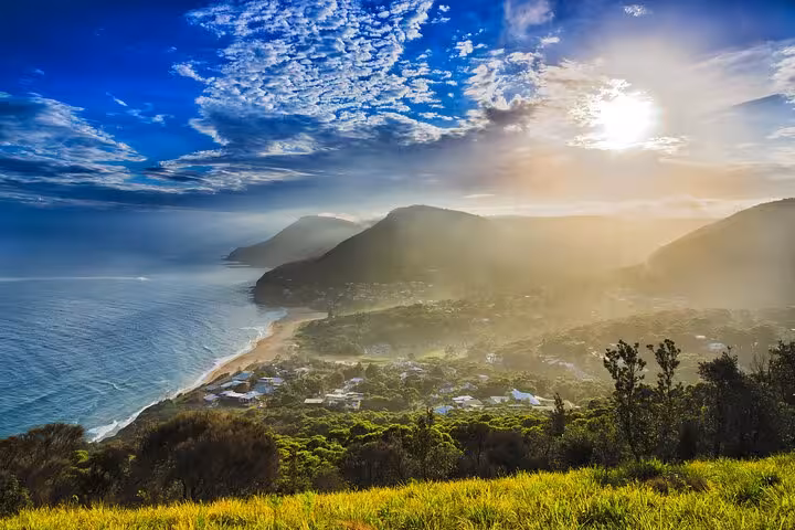 Breathtaking sunset over the coastline and hills on the South Coast private tour adventure.