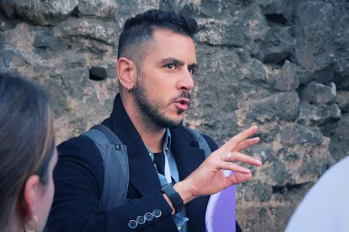 Tour guide passionately explaining Spanish Civil War history to visitors during private tour at historical site.