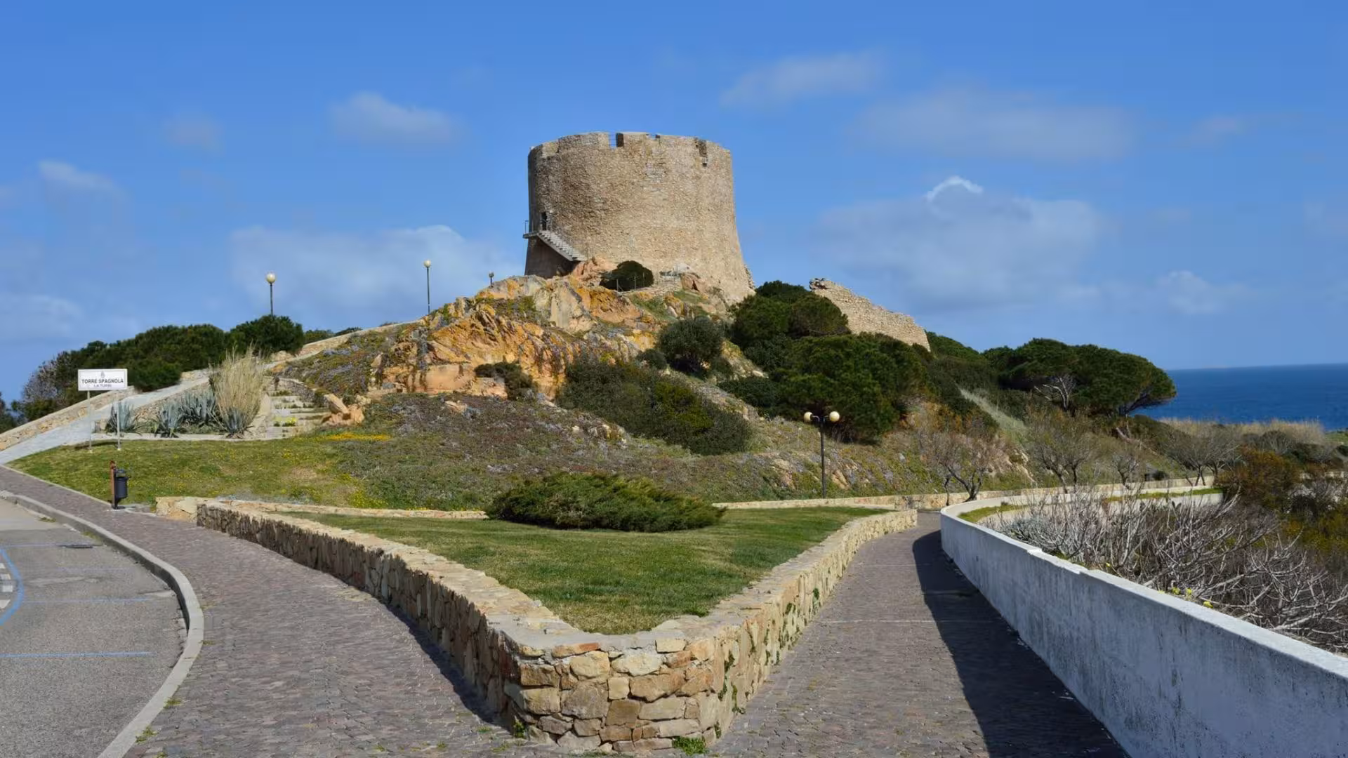 Historic Spanish Tower on a hill with scenic sea views in Santa Teresa Gallura, Sardinia, ideal for cultural tours.