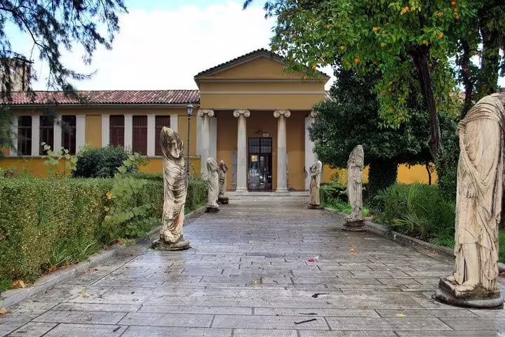 Courtyard walkway with statues at the Sparta Archaeological Museum, a highlight of a Sparta full day tour