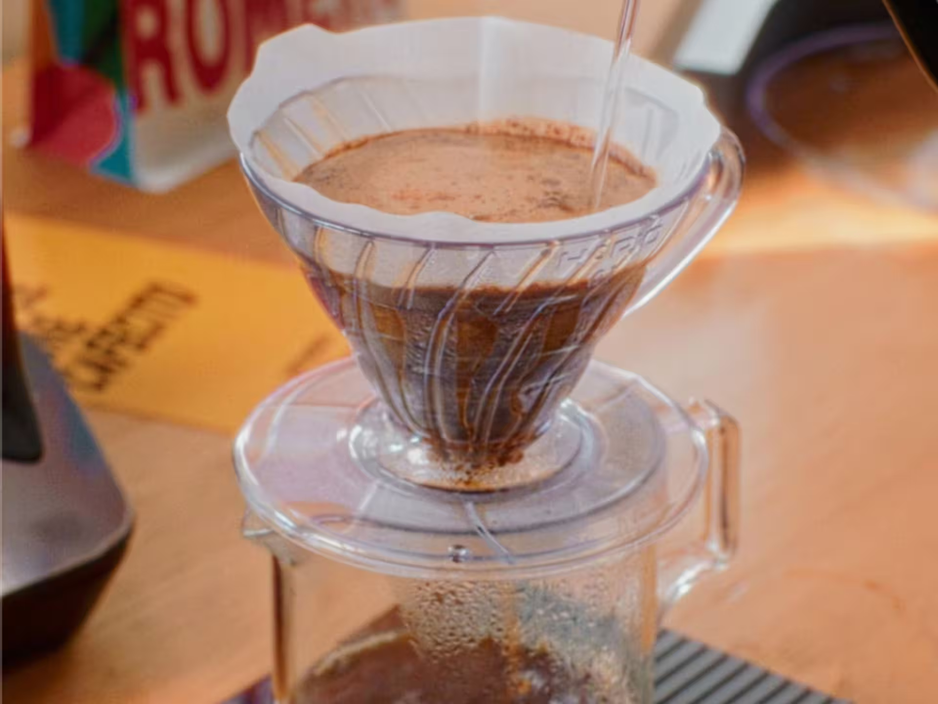 Close-up of pour-over coffee brewing at Turin's specialty roastery, highlighting the artisanal coffee-making process.
