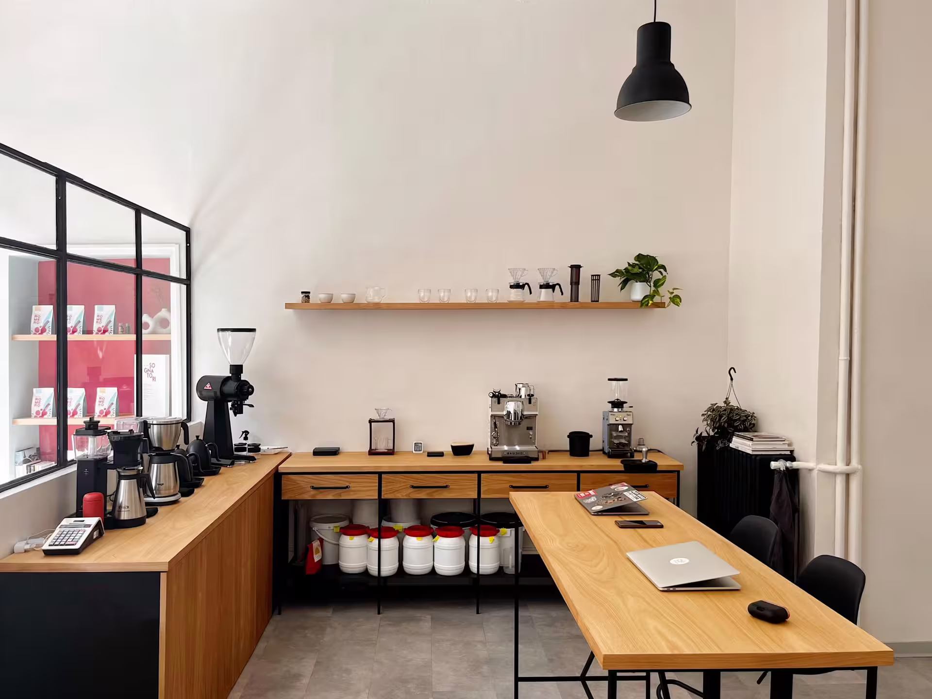 Modern coffee roastery setup in Turin with espresso machines and brewing equipment for a unique tasting experience.