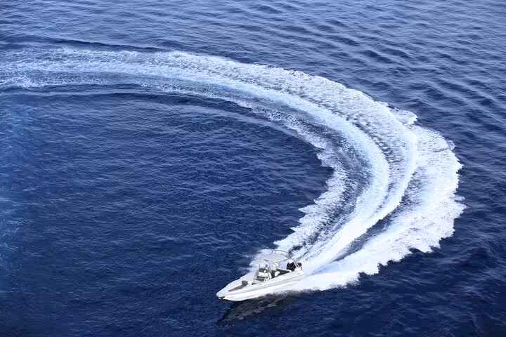 Speed boat carving a wide turn on the Red Sea in Sharm El Sheikh during a 2-hour private boat tour