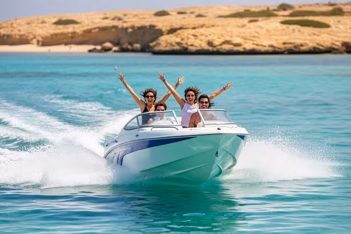 Friends riding a speed boat in Sharm El Sheikh, Red Sea, on a 2-hour private tour with scenic coast views