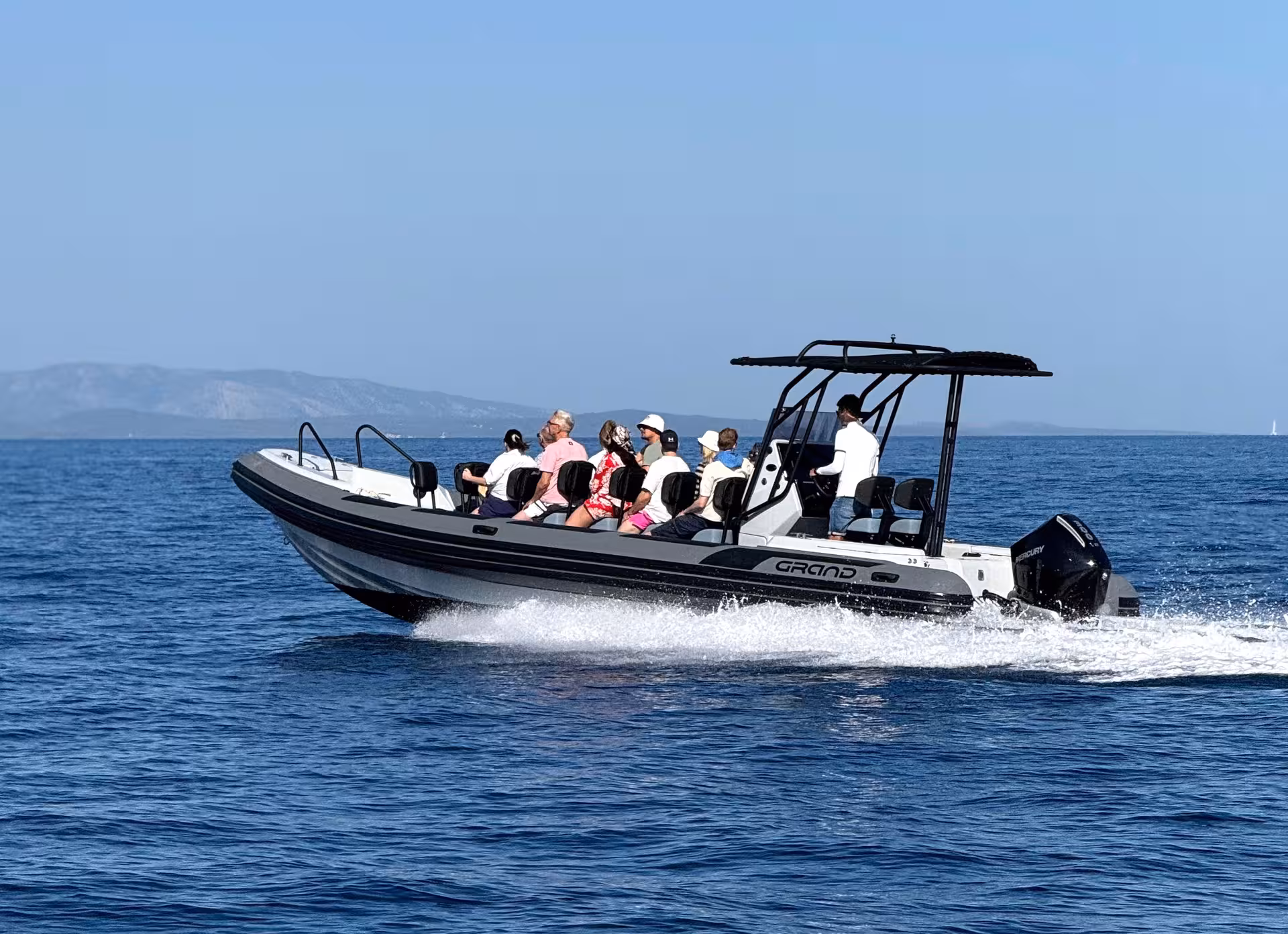Speedboat with passengers cruising the Adriatic on a half-day Brač Island tour to Golden Horn and hidden bays