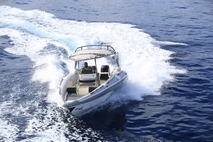 High-speed boat carving through Red Sea waves in Sharm El Sheikh during a 2-hour speedboat tour