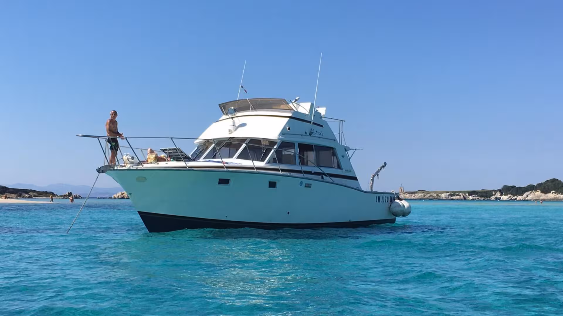 Speedboat anchored in turquoise waters near Santa Teresa di Gallura on a sunny Corsica tour day.