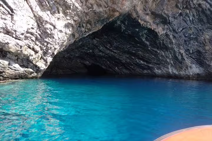 Dramatic sea cave entrance with crystal-clear waters, a must-see spot on the speedboat sun and snorkel adventure.