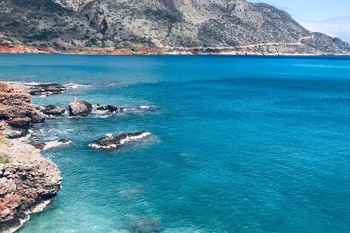 Stunning coastline with clear blue waters and rocky cliffs, perfect for a speedboat adventure.