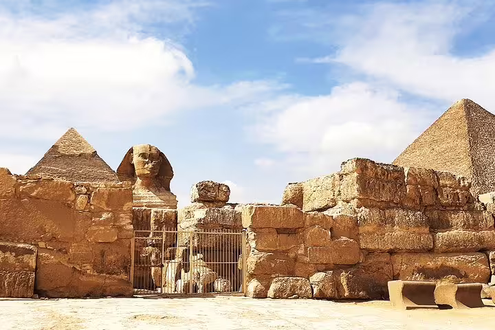 Sphinx enclosure and Giza pyramids under blue sky, private Cairo day tour to the Pyramids and Grand Egyptian Museum
