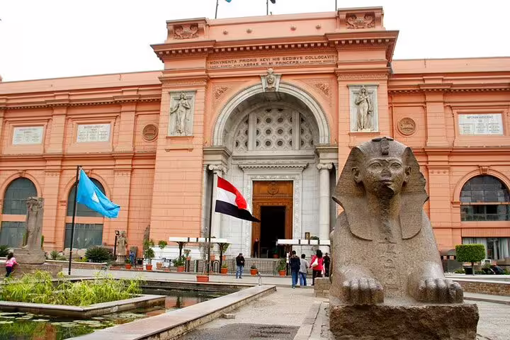 Sphinx statue and flags at Egyptian Museum Cairo entrance, key sight on National Museum and Citadel tour