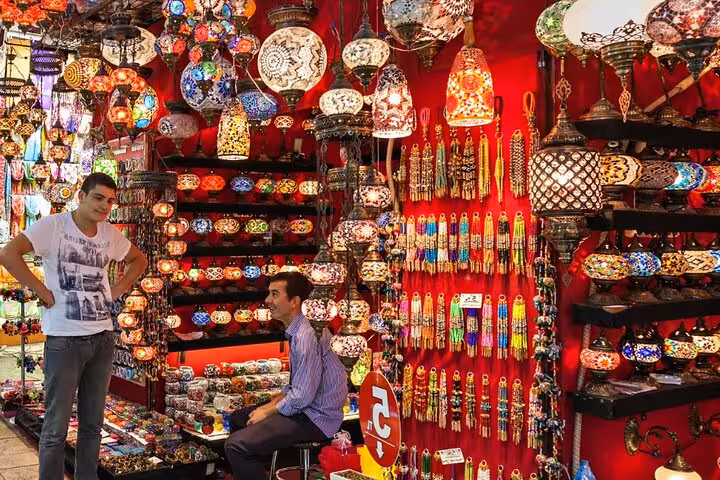 Spice Bazaar lamp shop in Istanbul with glowing Turkish mosaic lanterns, part of an all-inclusive guided city tour