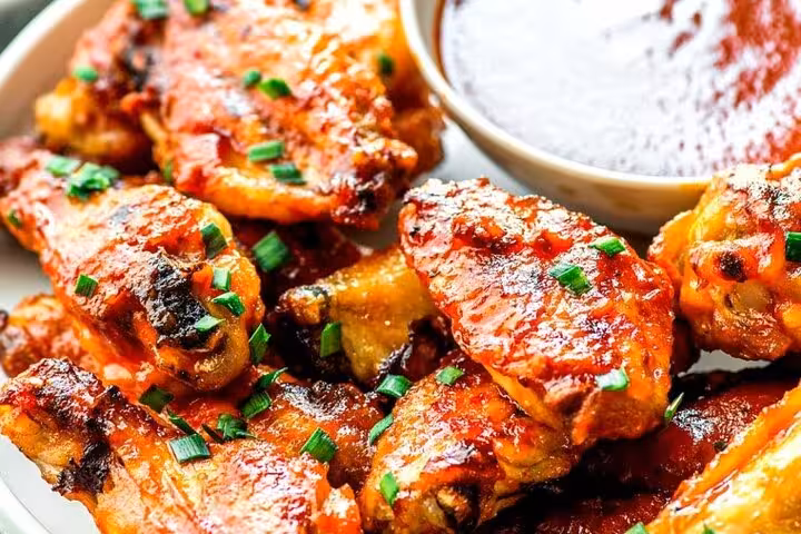 Spicy chicken wings with dipping sauce on Lisbon tavern food tour.