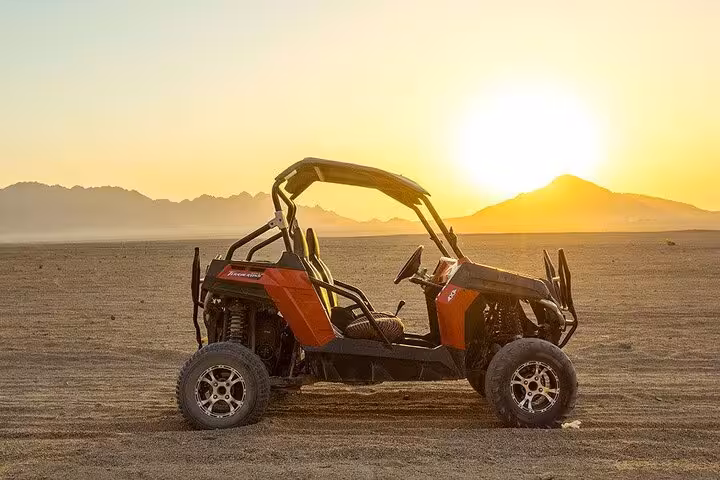 Spider buggy parked at sunset in Marsa Alam desert, scenic off-road adventure tour with optional camel ride