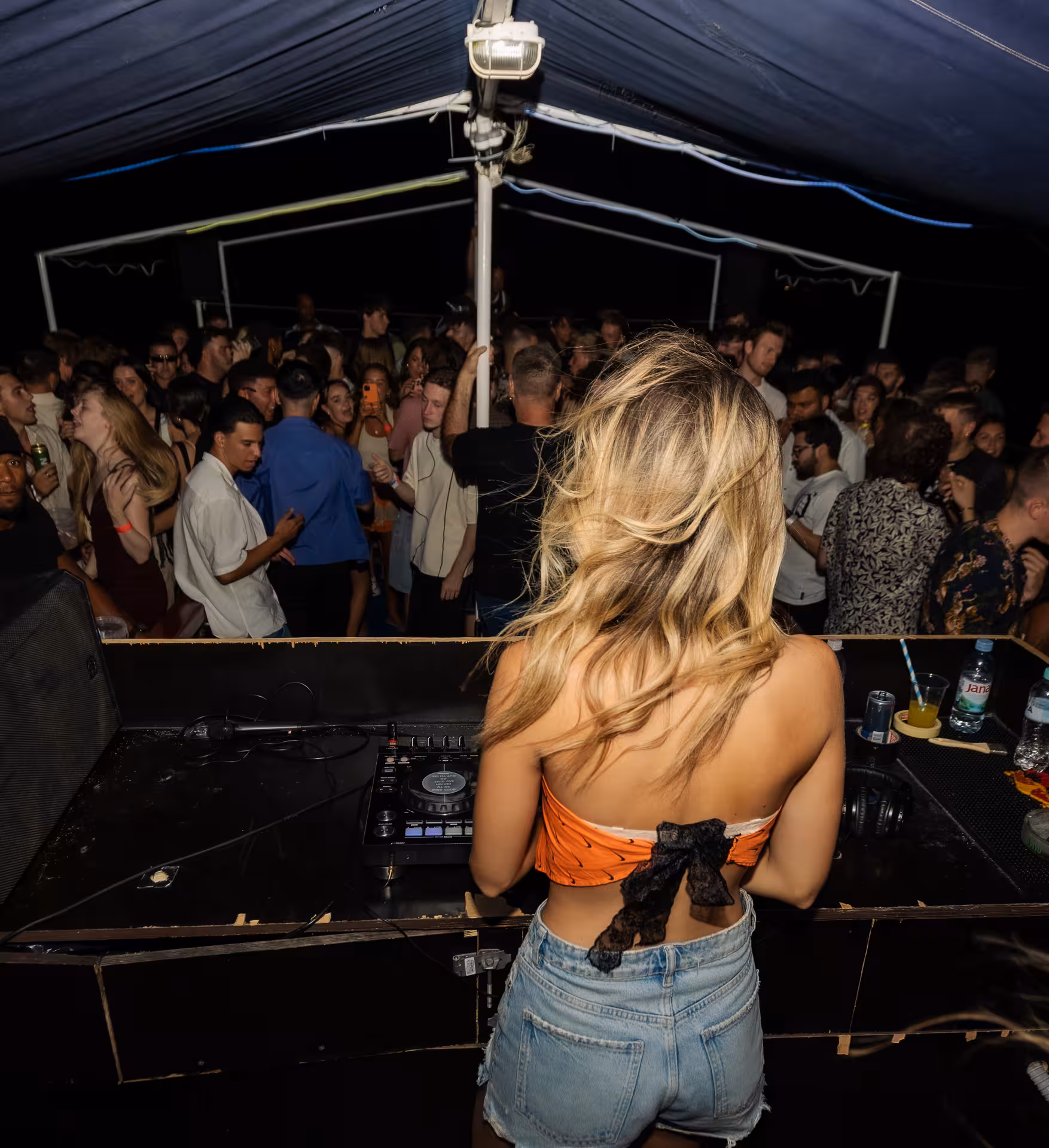 DJ playing music to a lively crowd on a boat during Split After Dark tour, featuring vibrant nightlife and dancing.