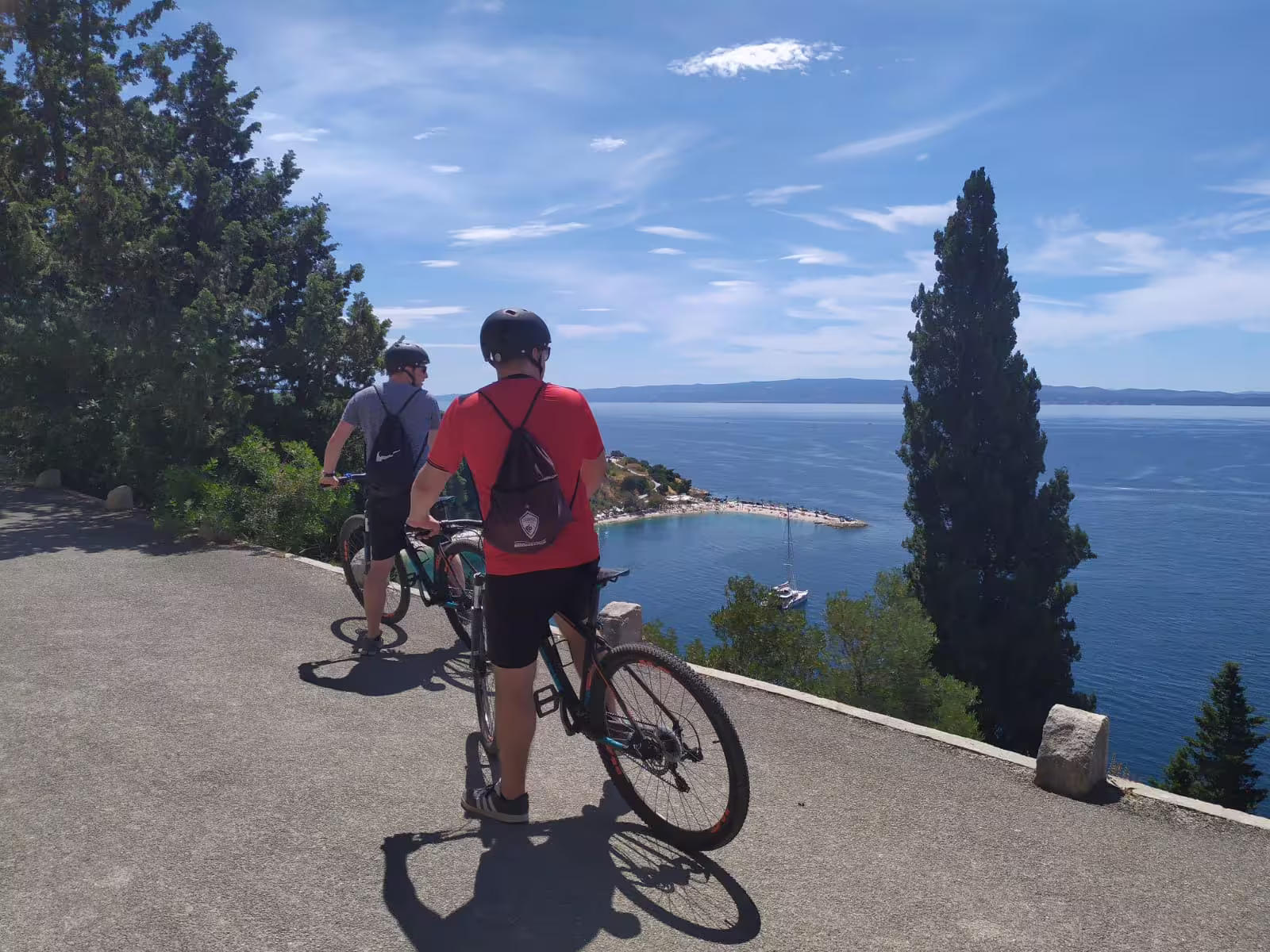 Cyclists pause at a scenic Adriatic viewpoint on Split bike tour, part of Bike Beer and Poljud Stadium experience