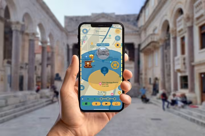 Hand holding smartphone displaying interactive map app for self-guided walking tour in Split Croatia historic old town
