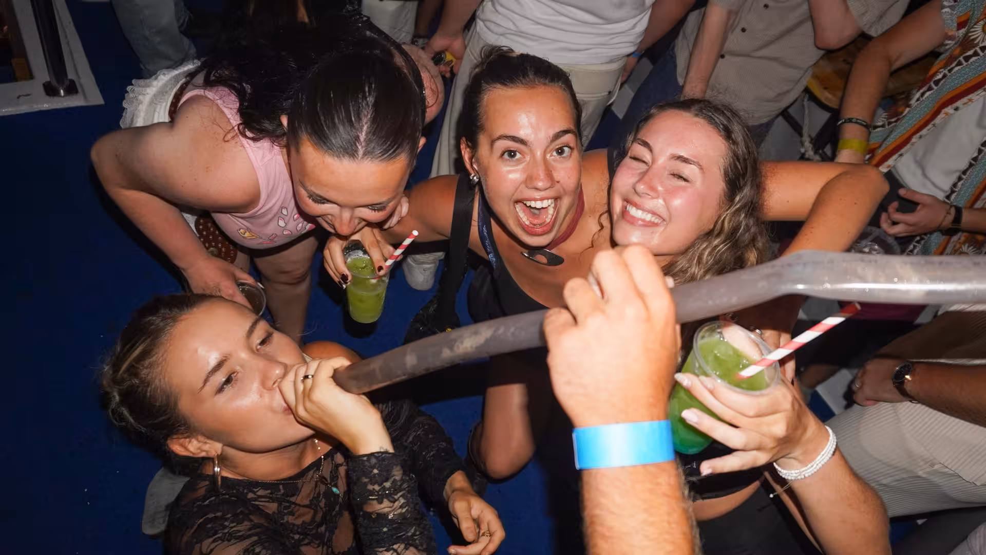 Group of friends having fun with drinks during a lively Split boat crawl party, highlighting the social vibe.