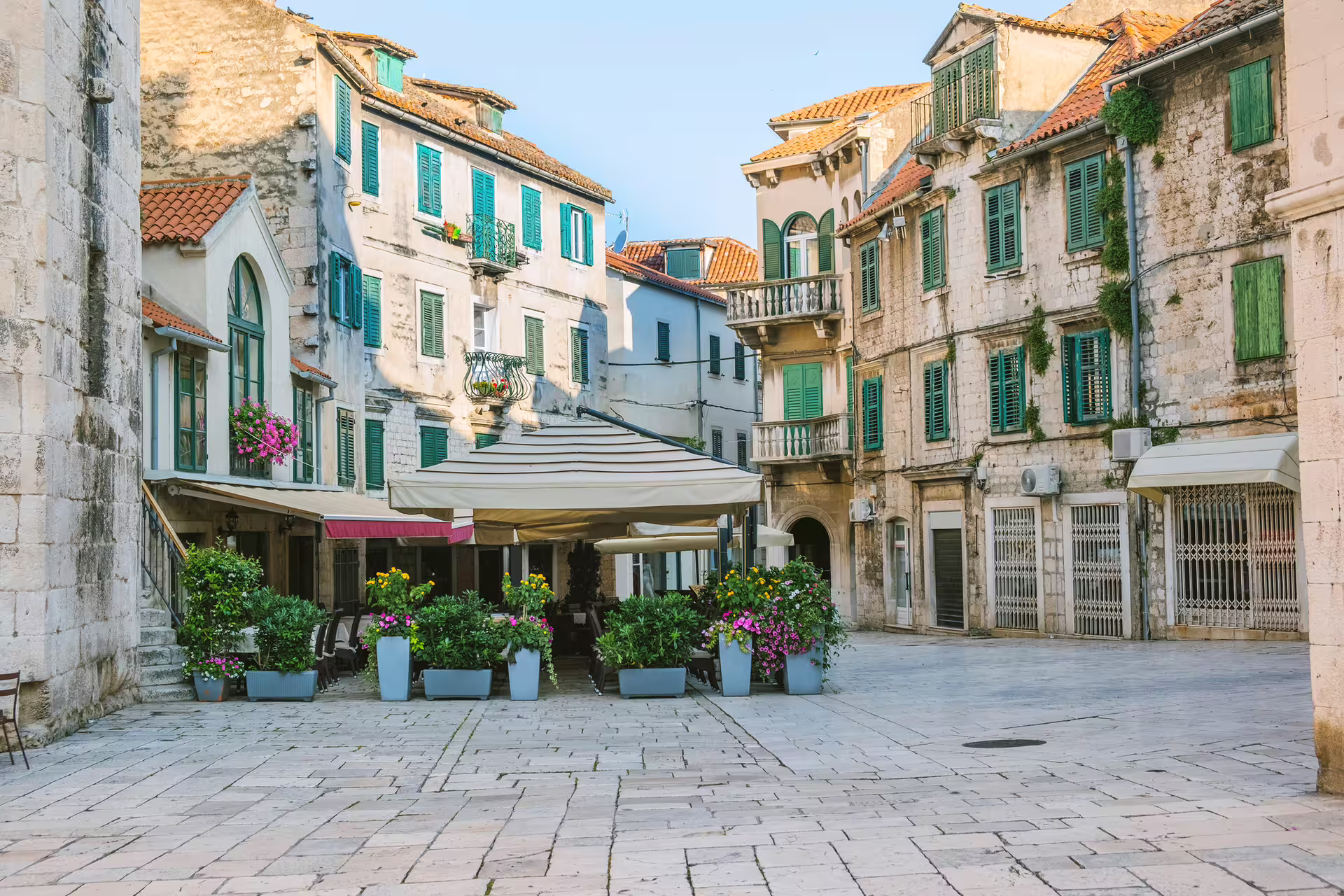 Quiet Split Old Town square with cafes and green shutters, scene from a Split in 1 day self-guided walking tour