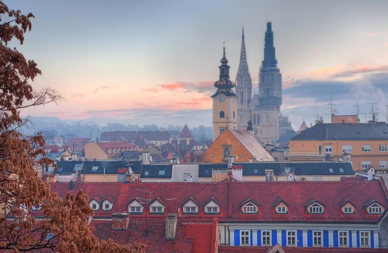 Sunset view over Zagreb rooftops with Zagreb Cathedral spires, scenic stop on Split and Zagreb private tour