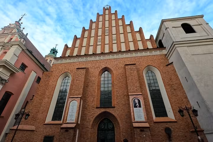 Gothic facade of St. John's Cathedral in Warsaw Old Town explored on a self-guided medieval Warsaw walking tour