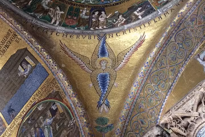 Detailed mosaic of angelic figure with wings inside St. Mark's Basilica, Venice, showcasing exquisite artistry and history.